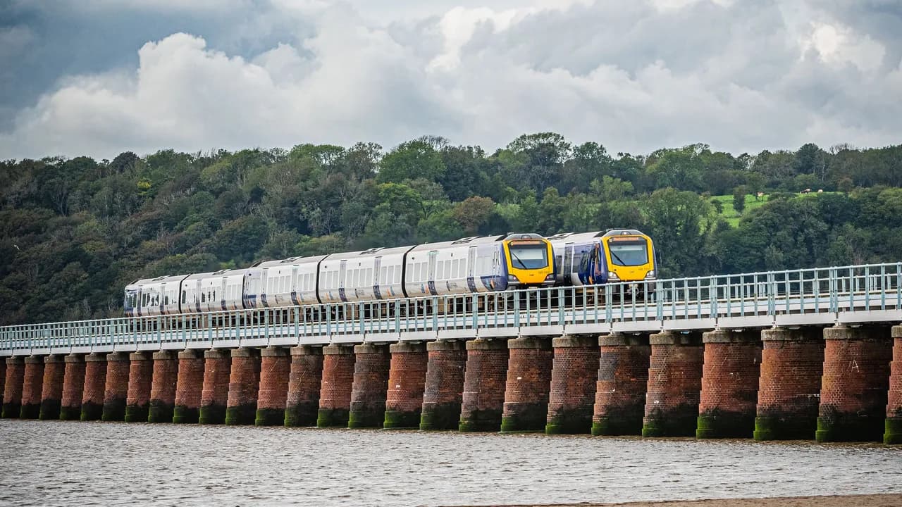 Two Northern trains crossing Arnside Viaduct over the Kent estuary, on the Furness line that runs round to the Cumbrian Coast