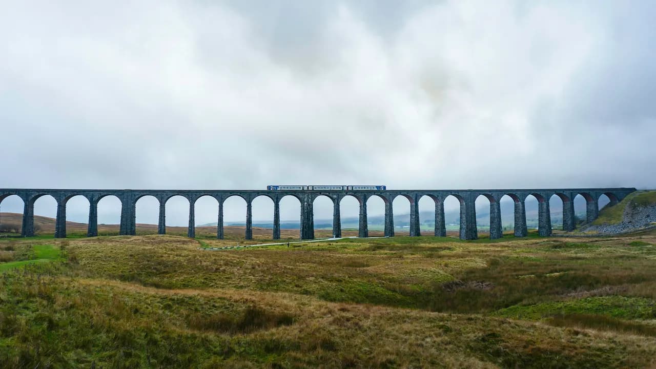 A Northern train crossing the twenty-four arches of Ribblehead Viaduct on the Settle to Carlisle line